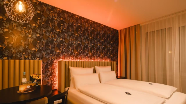 Modernes Hotelzimmer mit großem Doppelbett und Beleuchtung